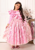Young girl wearing a pink ruffled gown with floral lace details, posing against a soft, white backdrop.