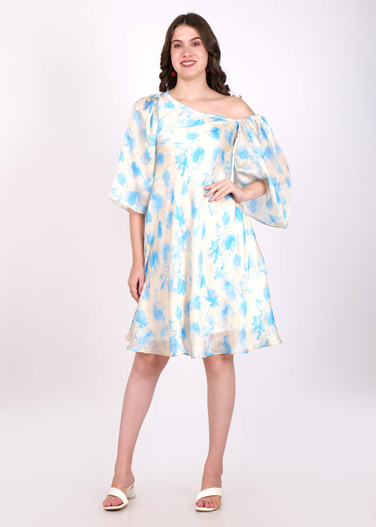 Woman wearing an off-shoulder floral print cream dress with blue flowers