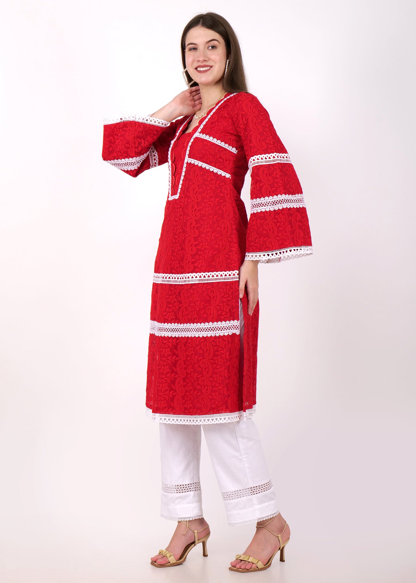 A model displaying the side view of a red lace kurta set, featuring intricate white lace patterns on the sleeves and hem