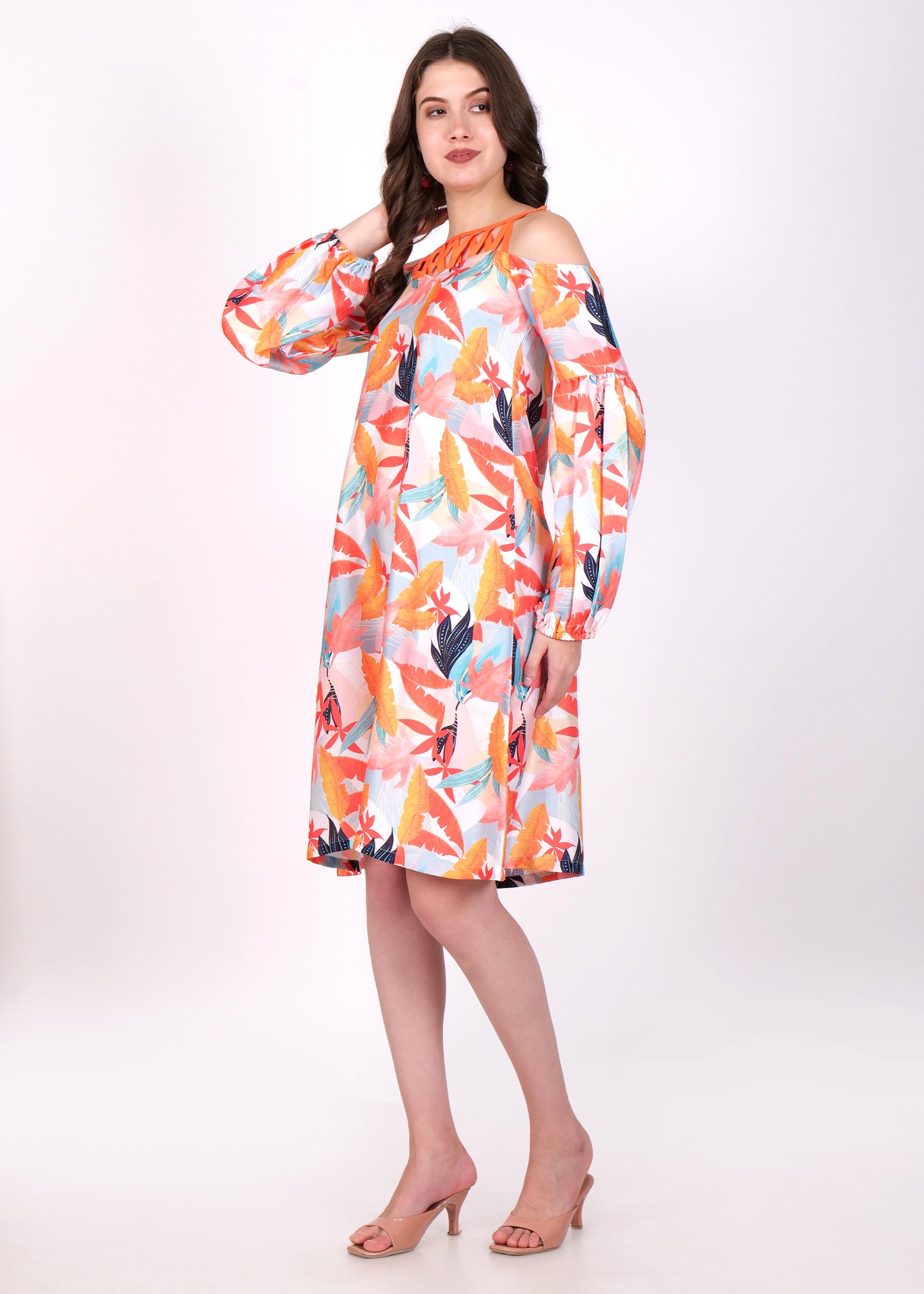 Side view of a model wearing a colorful tropical leaf print off-shoulder dress with balloon sleeves