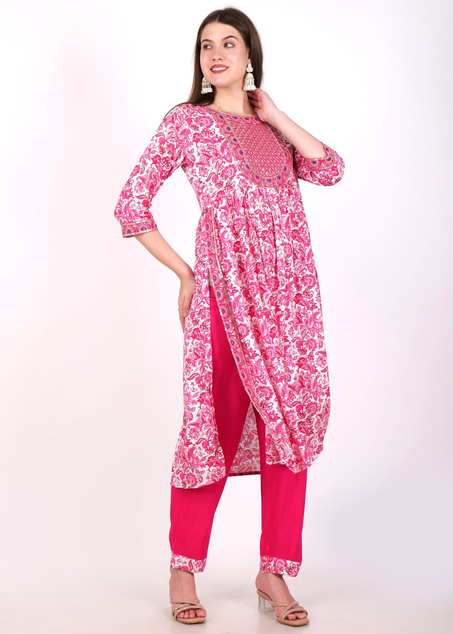 Side view of a model in a pink embroidered kurta paired with matching pink pants, showcasing the flowy design.