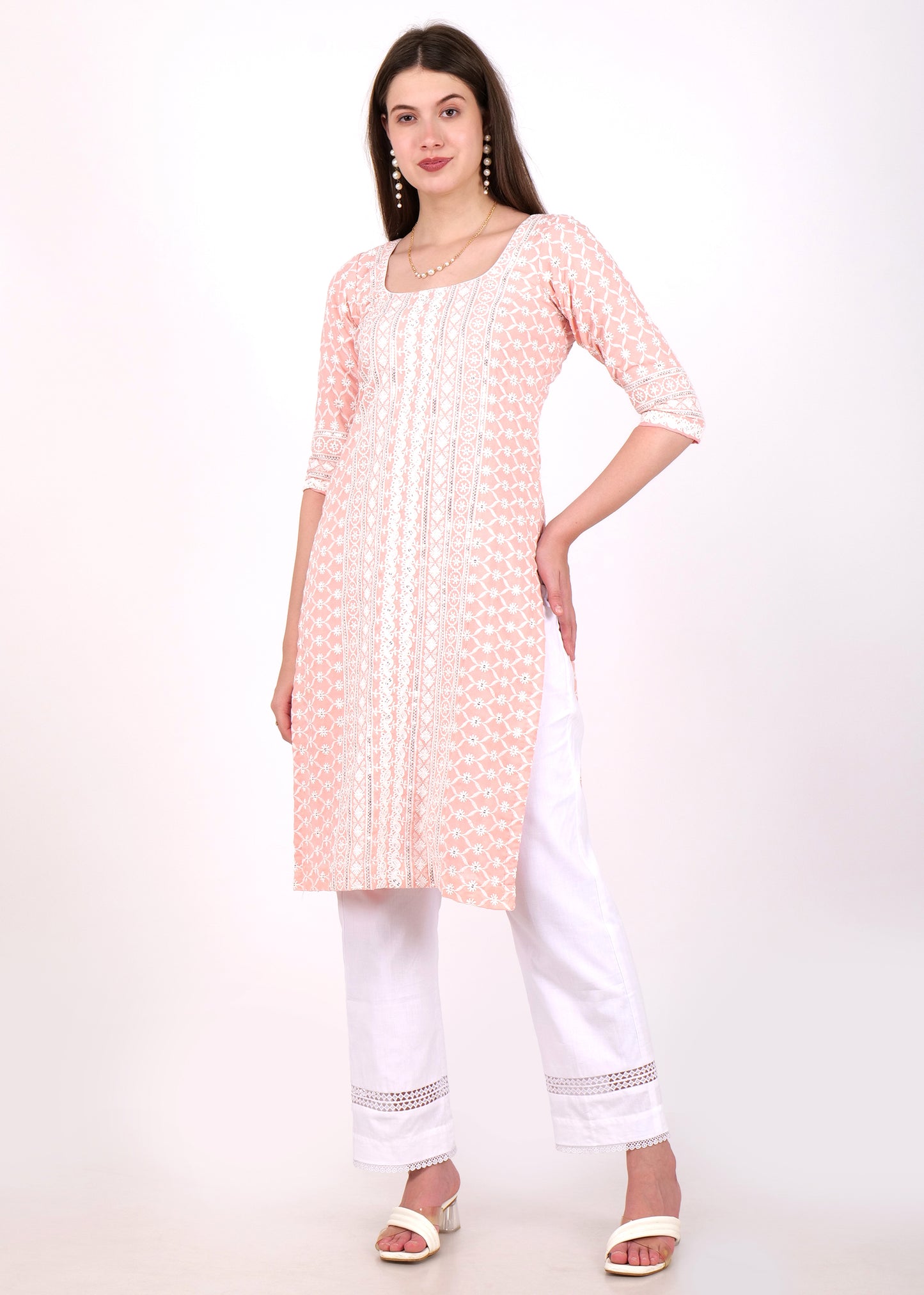 Side view of model in light pink embroidered cotton kurta with white trousers, showcasing lace sleeve details