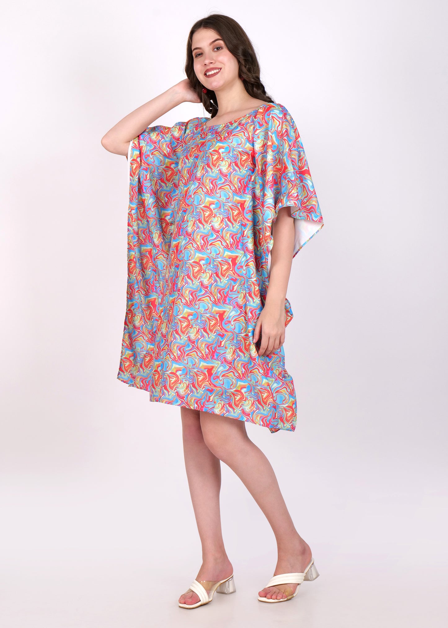 Side view of a model in a vibrant kaftan dress featuring a multicolor swirl pattern, showcasing the flowy design
