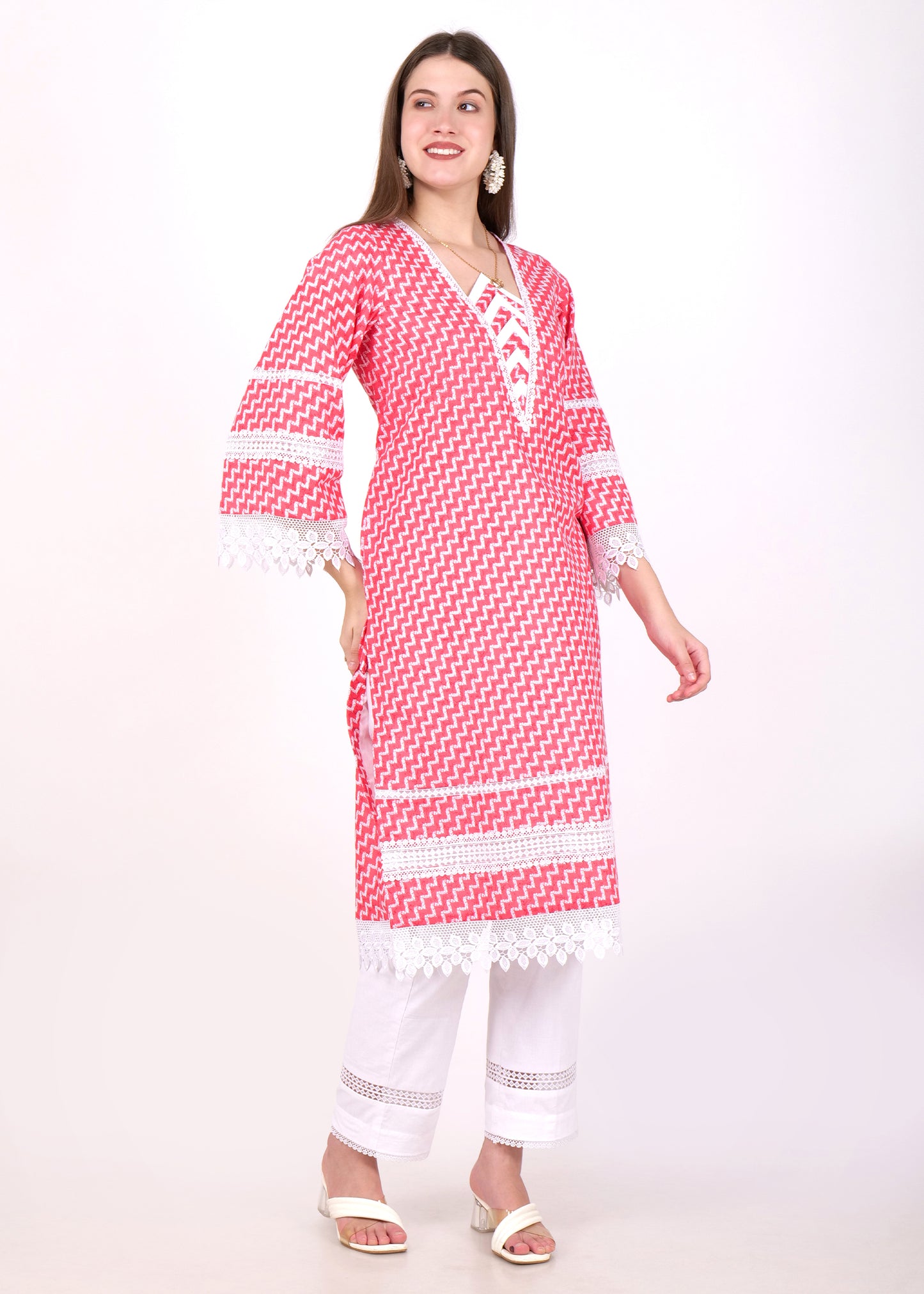Model wearing a red and white zigzag pattern kurta, smiling and posing, highlighting the intricate lace detailing on the sleeves and hem.