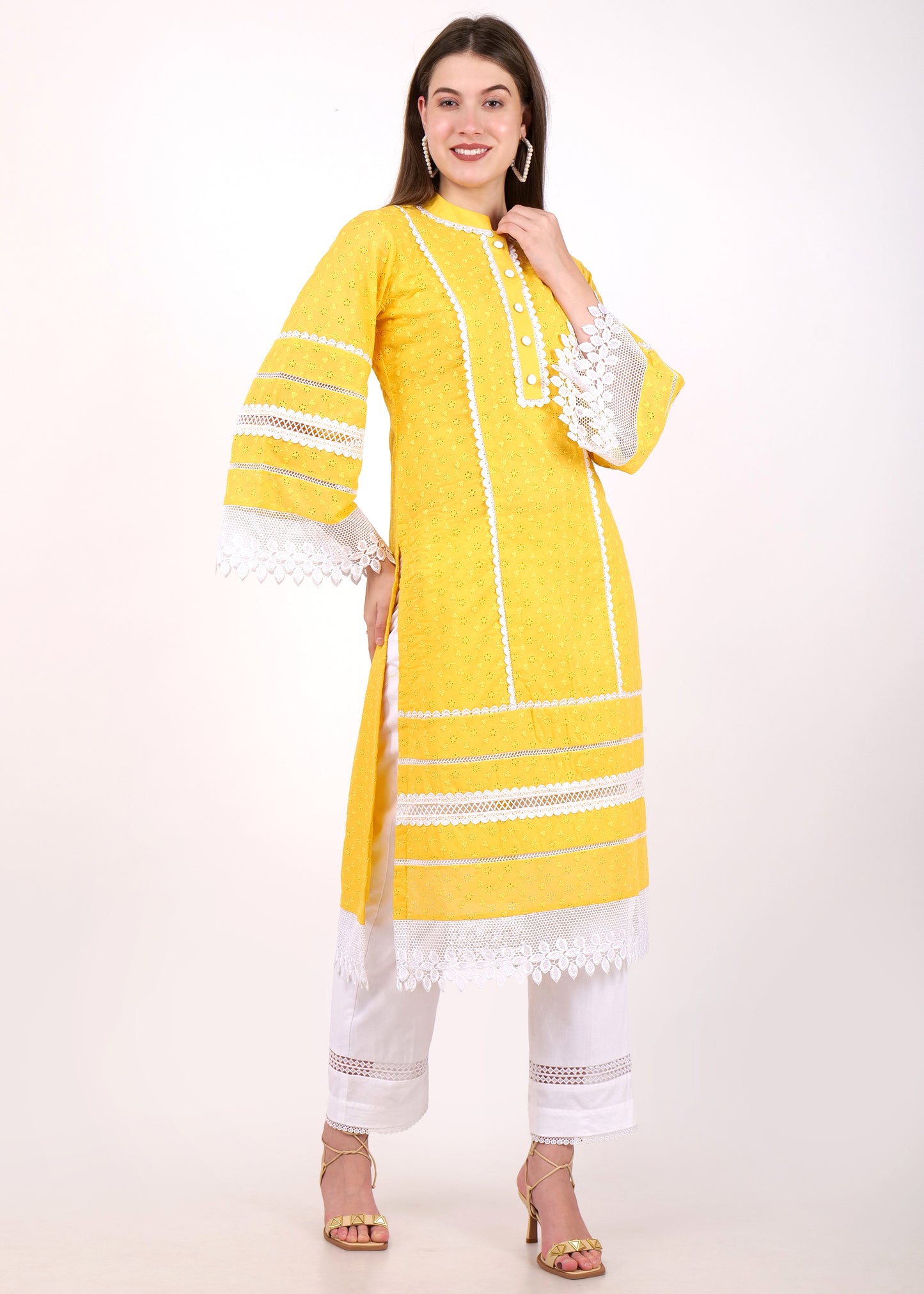 Model wearing a yellow embroidered kurta with intricate lace trims and bell sleeves, complemented with white pants, showcasing a chic and ethnic vibe.