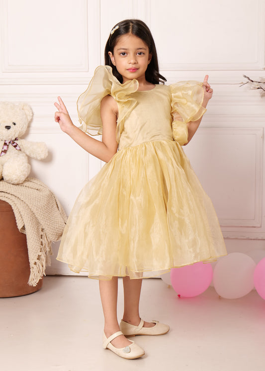 "Young girl in an elegant gold party dress with puff sleeves, striking a playful pose with peace signs, showcasing the soft flow of the outfit."