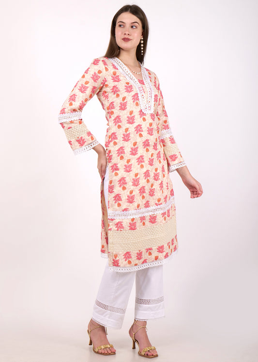 Model showcasing a beige and pink floral printed kurta with intricate lace details, worn with white pants