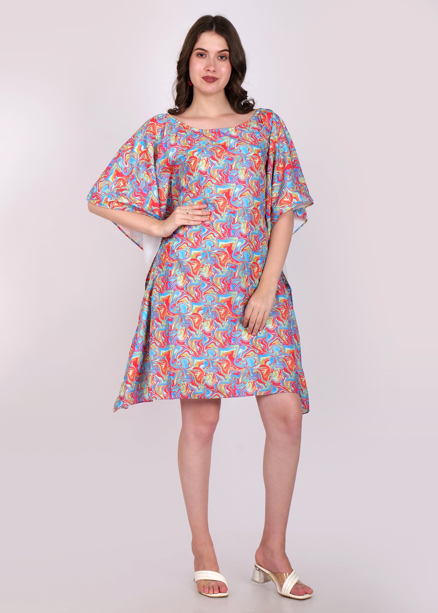 Front view of a model in a multicolor swirl patterned kaftan dress, highlighting the loose fit and relaxed style