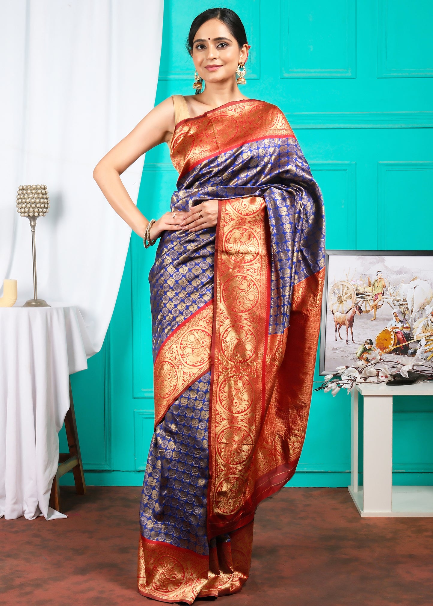 Woman in a regal blue and red Banarasi silk saree, posing elegantly in a traditional setting, ideal for grand celebrations