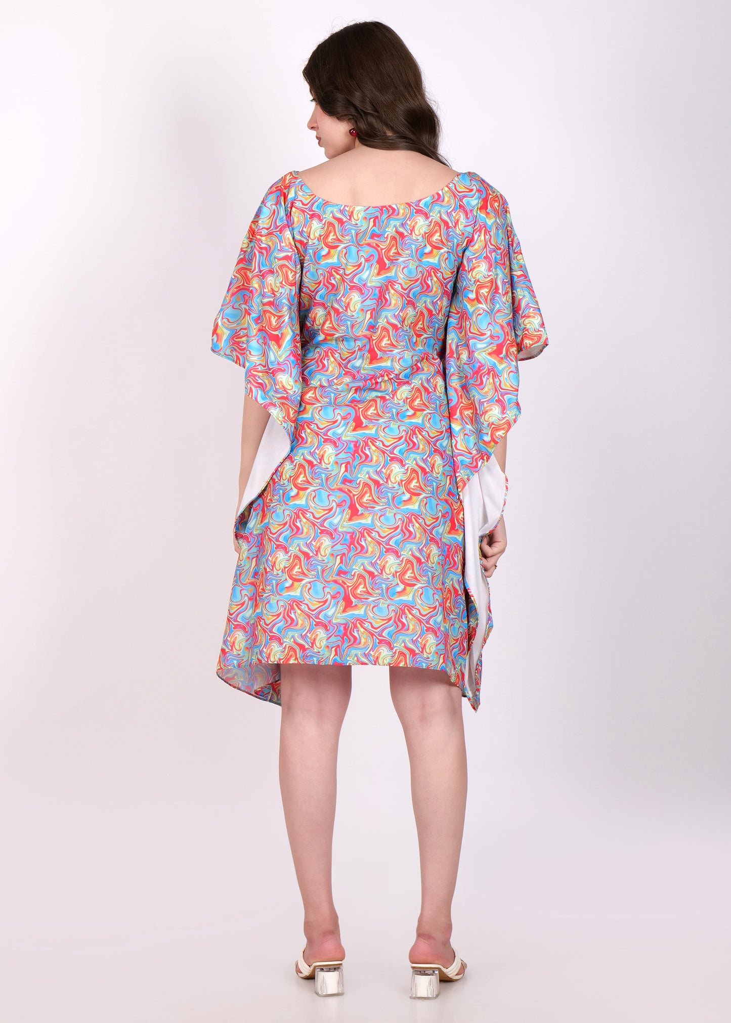 Back view of a colorful swirl print kaftan dress, showing the free-flowing fabric and wide sleeves
