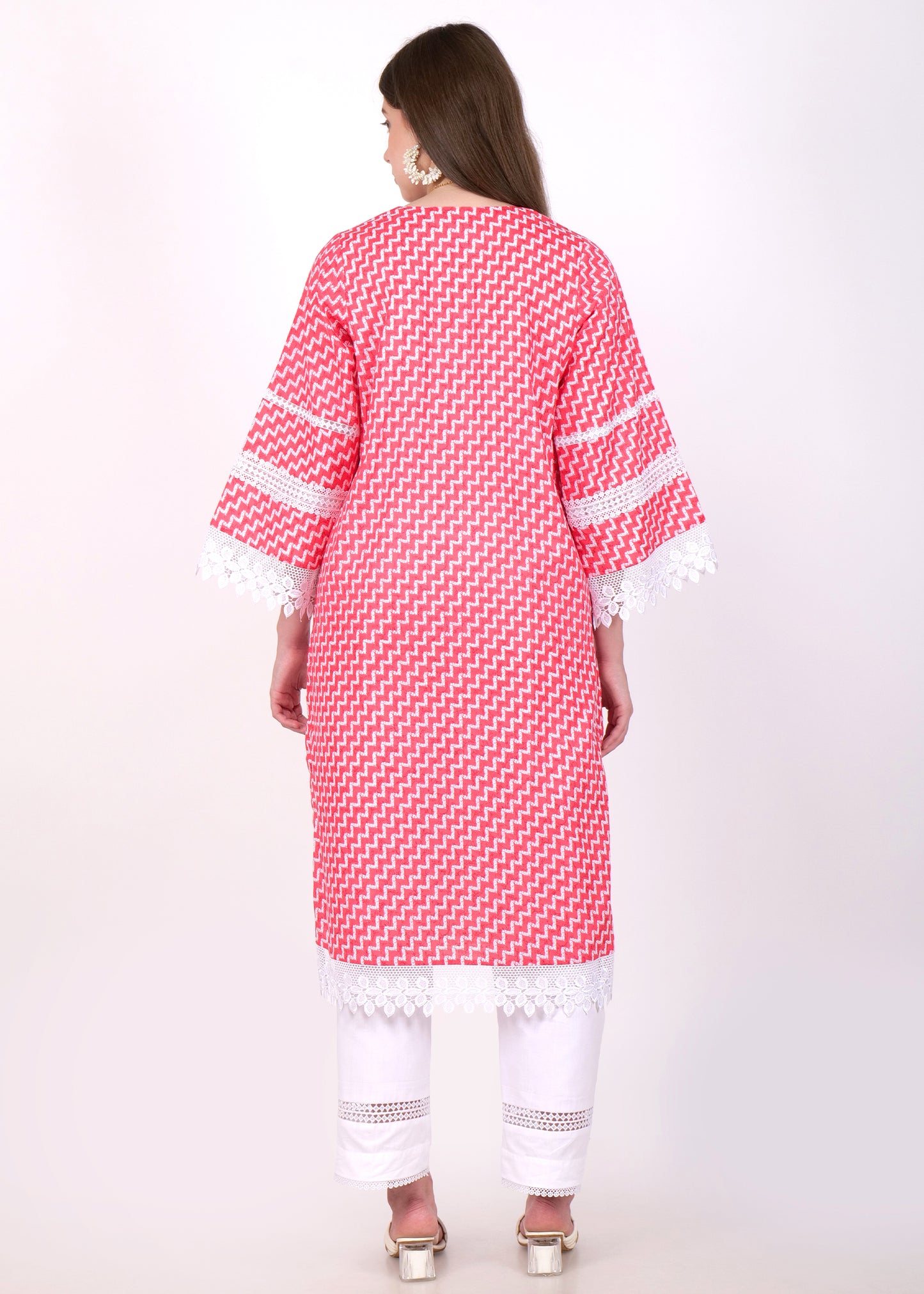 Back view of a red and white zigzag printed kurta, worn by a woman, accentuating the lace details on the sleeves and the hemline.
