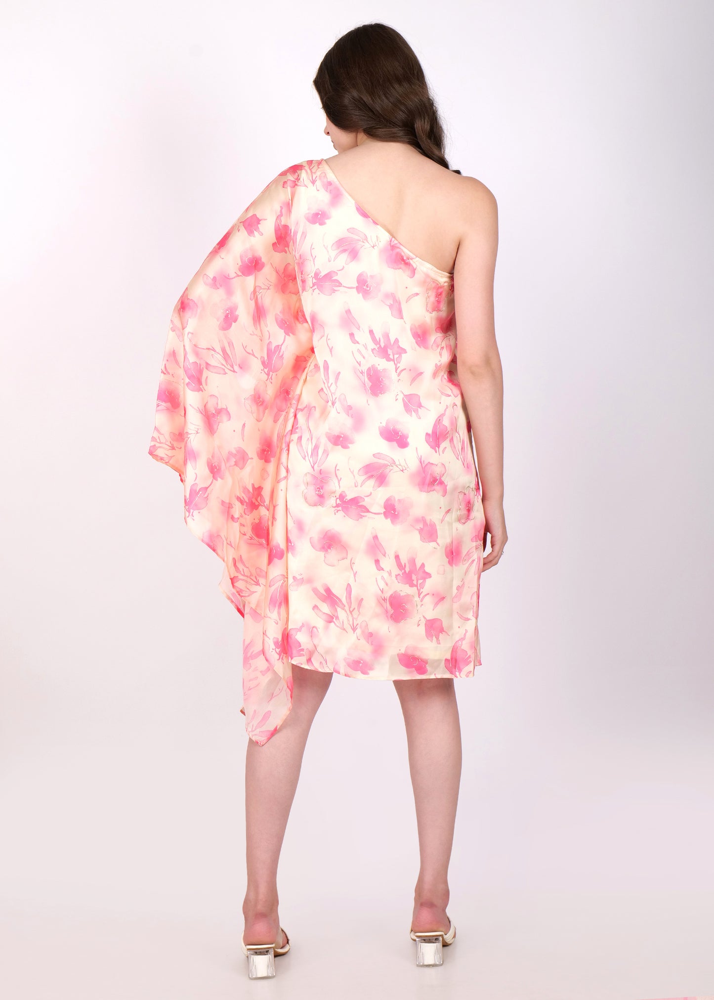 Back view of a one-shoulder pastel floral dress with delicate pink watercolor flower