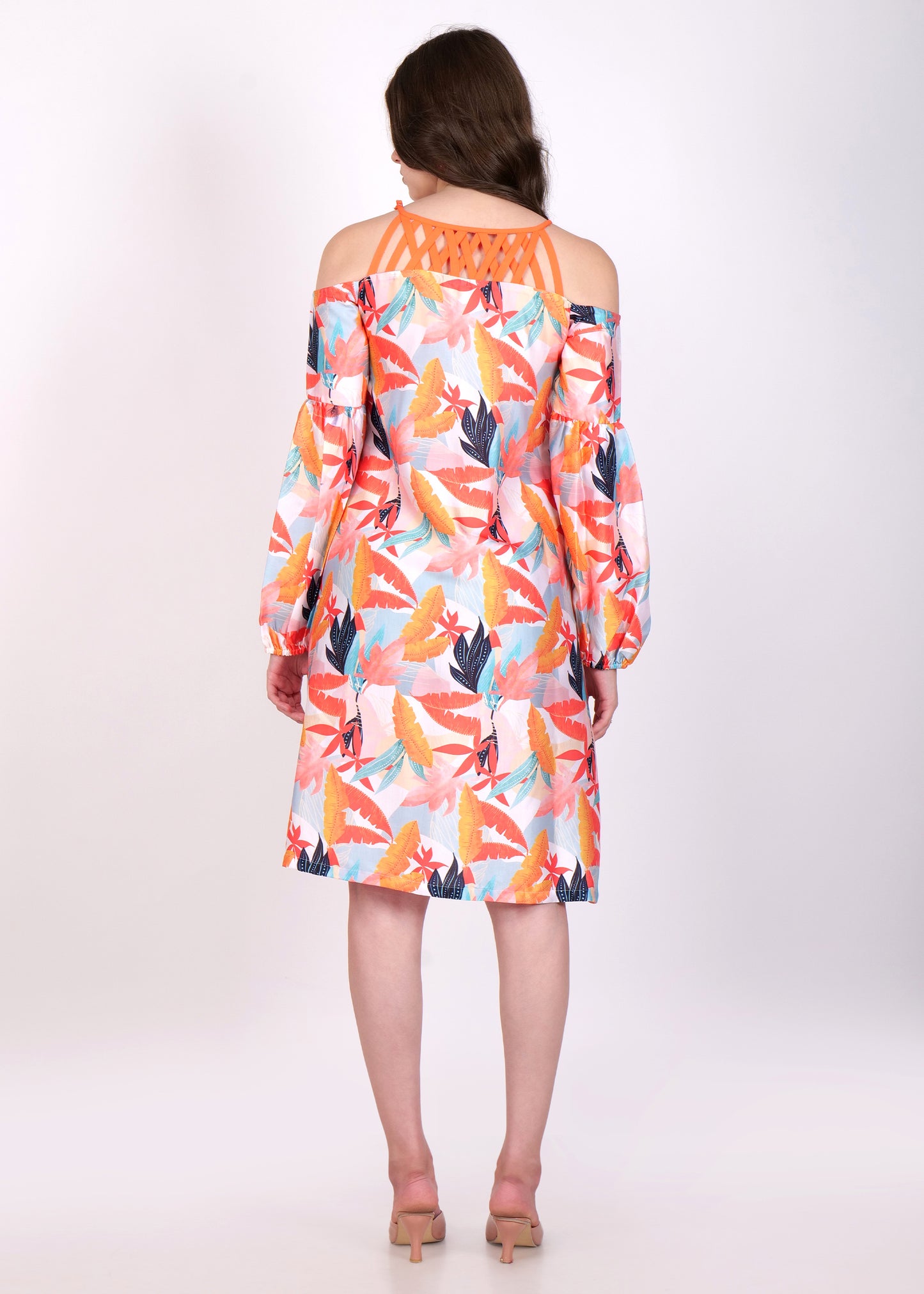 Back view of tropical leaf print dress with criss-cross orange straps and off-shoulder design.