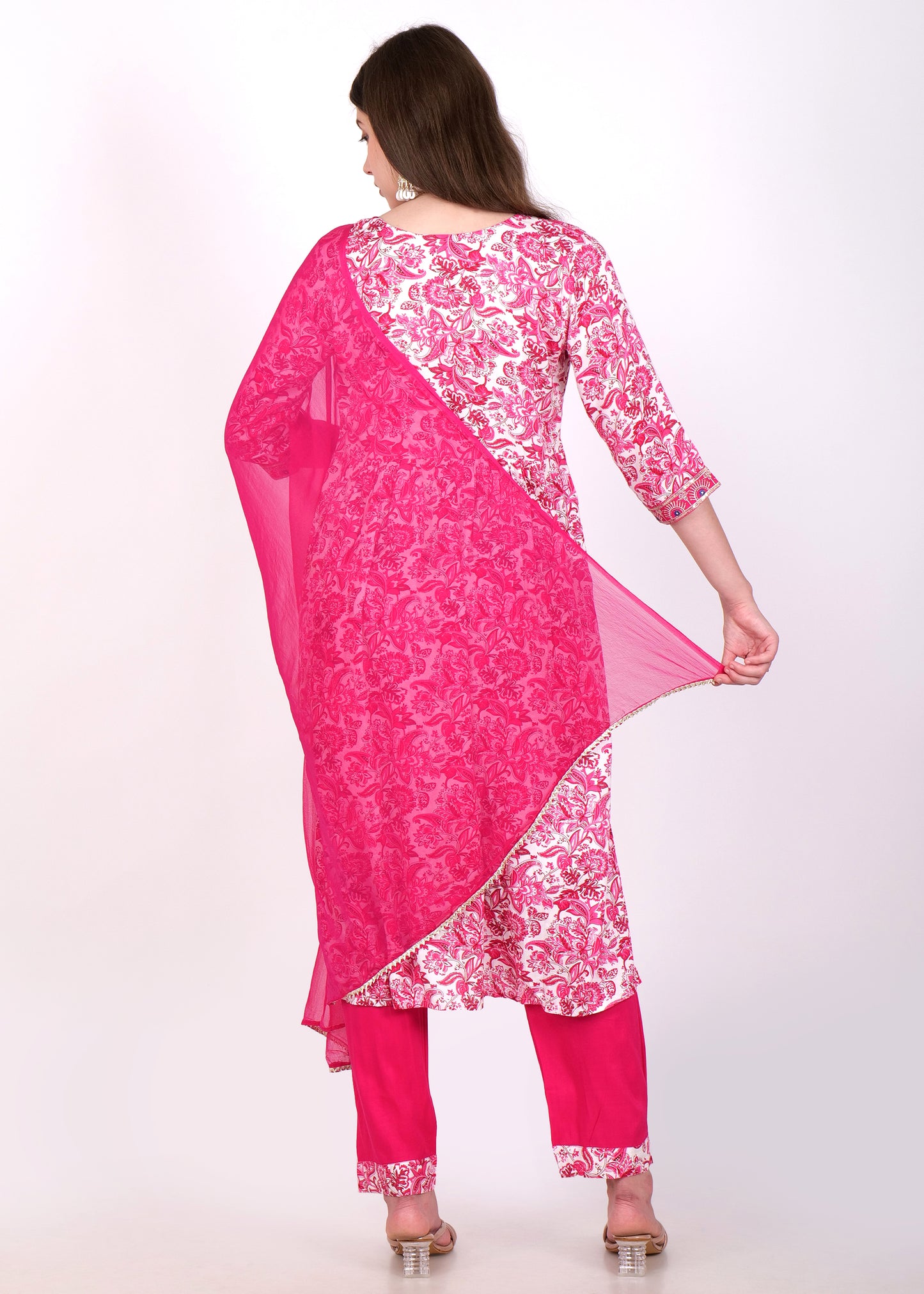 Back view of a model in a pink embroidered kurta and matching pants, holding a flowing dupatta.