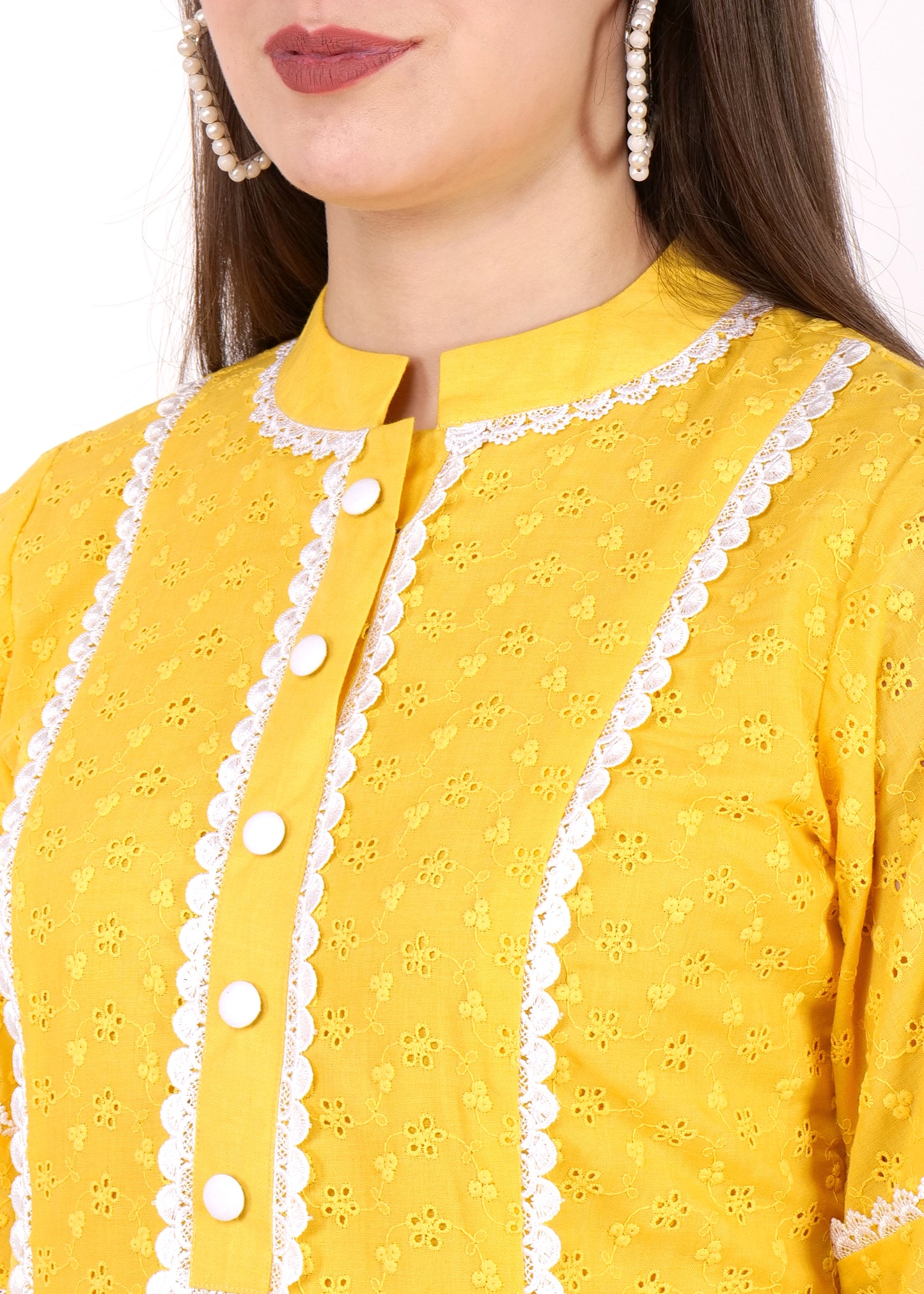Close-up of yellow kurta showcasing intricate embroidery, buttoned neckline, and white lace detailing on the collar and front panel