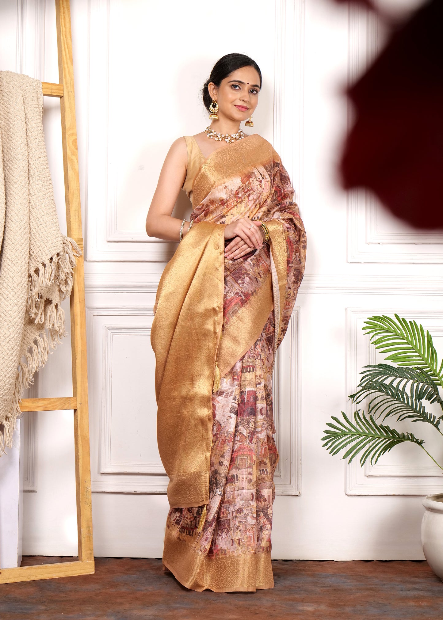 Elegant model in a golden Krishna Rasleela print Banarasi saree, showcasing intricate detailing and luxurious fabric with a serene expression
