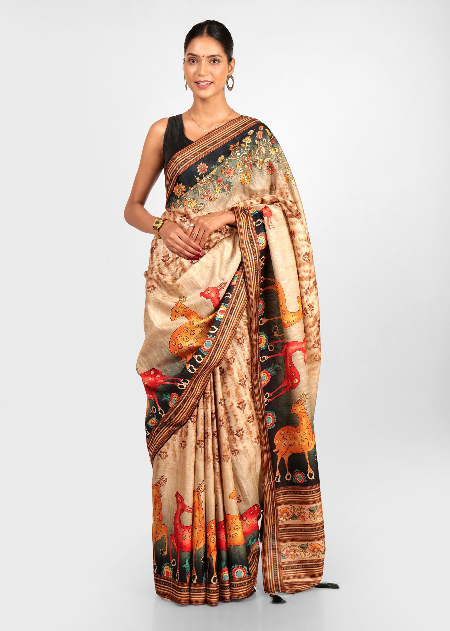 Close-up of saree’s border showcasing detailed floral embroidery and geometric patterns on a black background.
