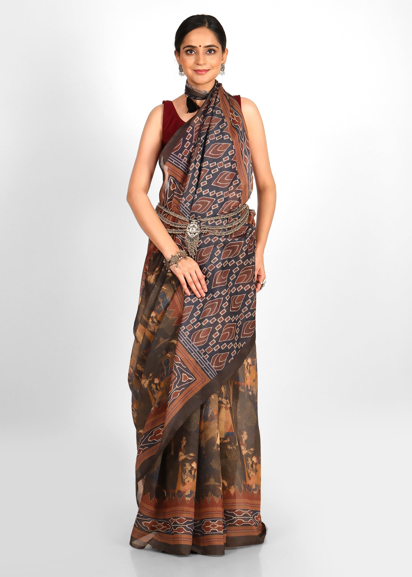 Detailed shot of the geometric Ikat pattern on the pallu of the earthy tone saree