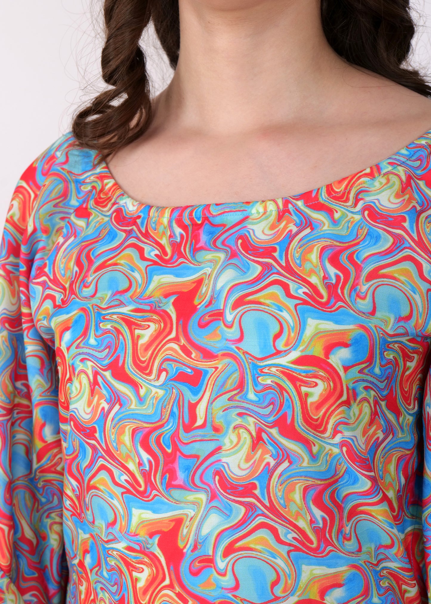Close-up of the colorful swirl print fabric on a kaftan dress, focusing on the detailed pattern and neckline