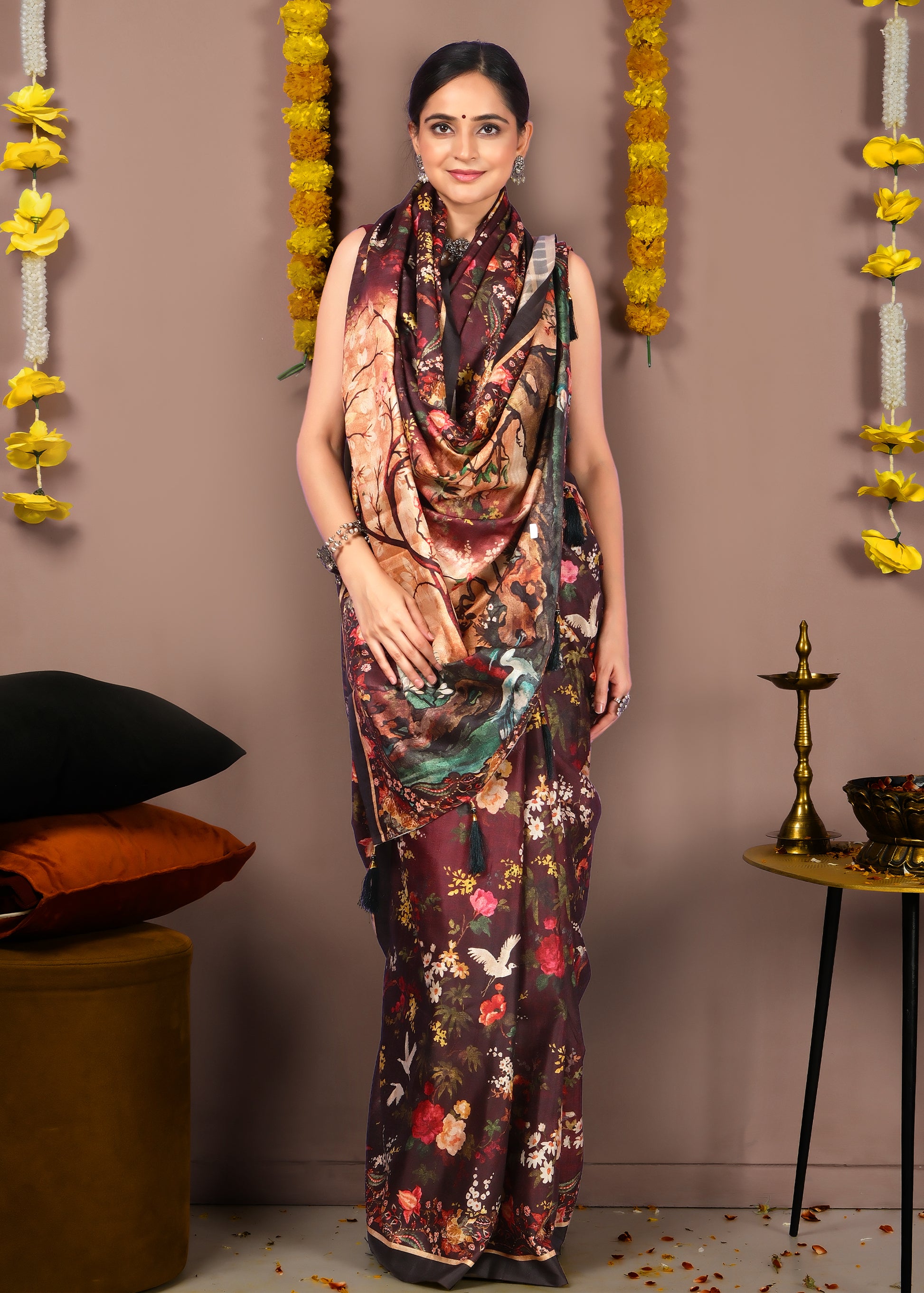 Model showcasing a maroon floral print saree with nature-inspired motifs and intricate designs, styled elegantly with traditional jewelry