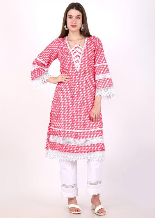 Woman wearing a red zigzag printed kurta with white lace detailing, paired with white pants and open-toe sandals, showcasing a modern ethnic look.