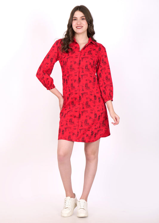 Woman wearing a red printed shirt dress with long sleeves, button-up design, and black abstract patterns, styled with white sneakers.