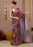 Woman draped in a Krishna Rasleela print Ikat saree with vibrant earthy tones and detailed geometric borders.