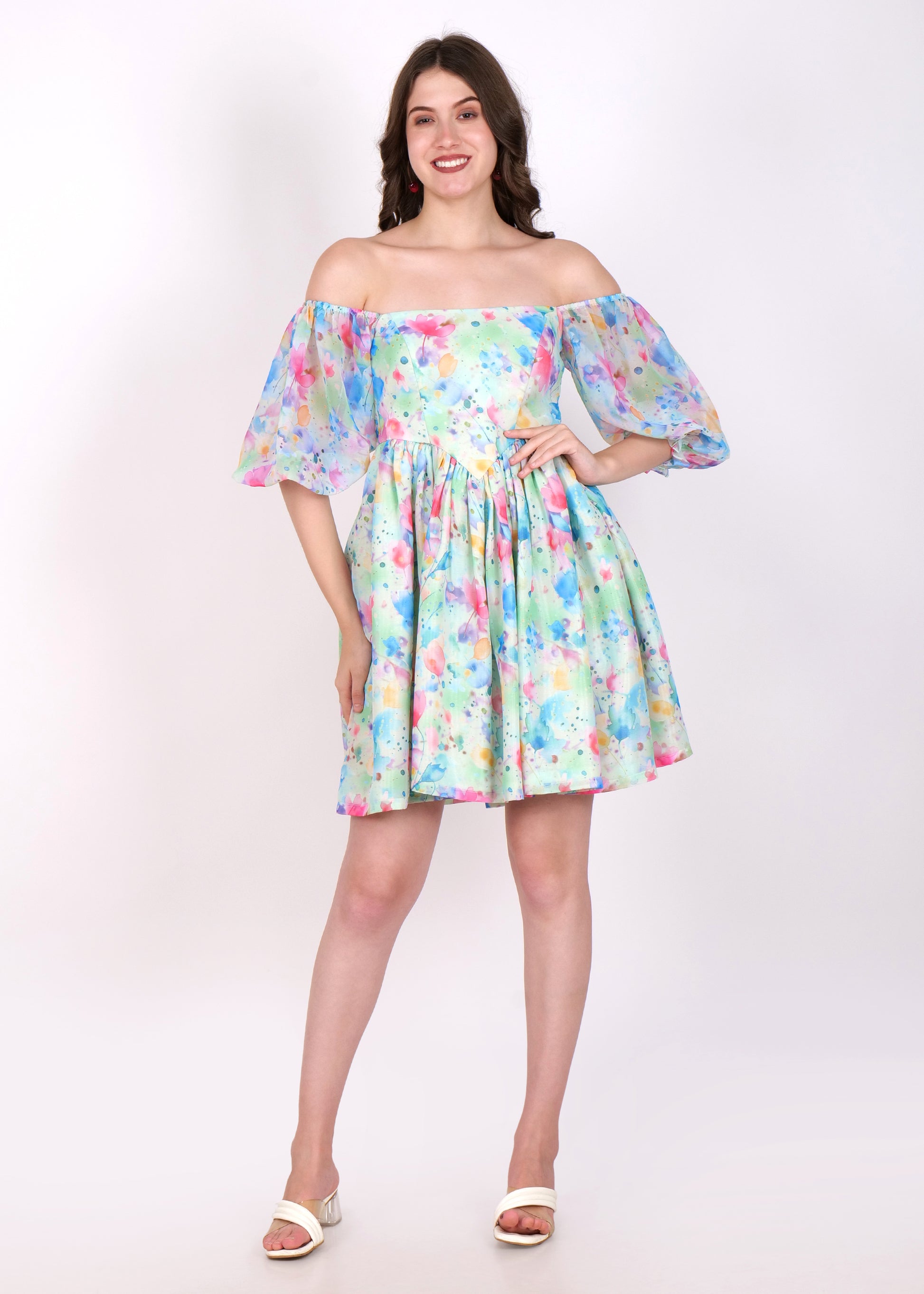 Model wearing a pastel floral watercolor print off-shoulder dress with puffy sleeves