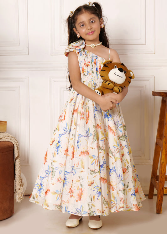 Girl in a floral sleeveless dress holding a plush tiger, posing with a soft smile in a pastel-colored dress with floral prints