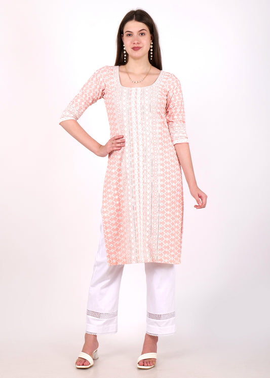 Model wearing light pink embroidered cotton kurta with lace detailing and white trousers, front view