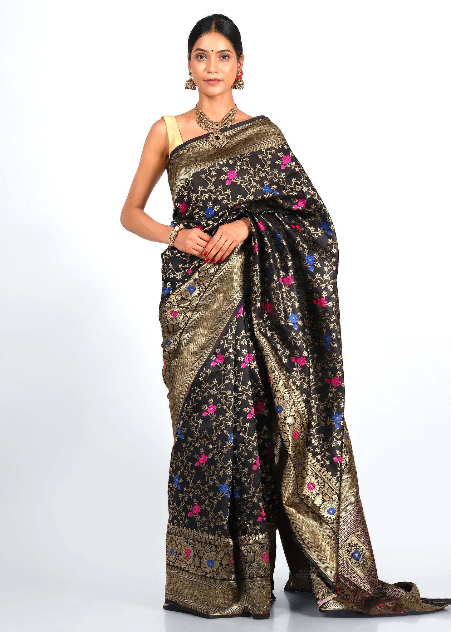 Model wearing a luxurious black Banarasi silk saree with intricate gold zari work and vibrant floral accents in pink and blue