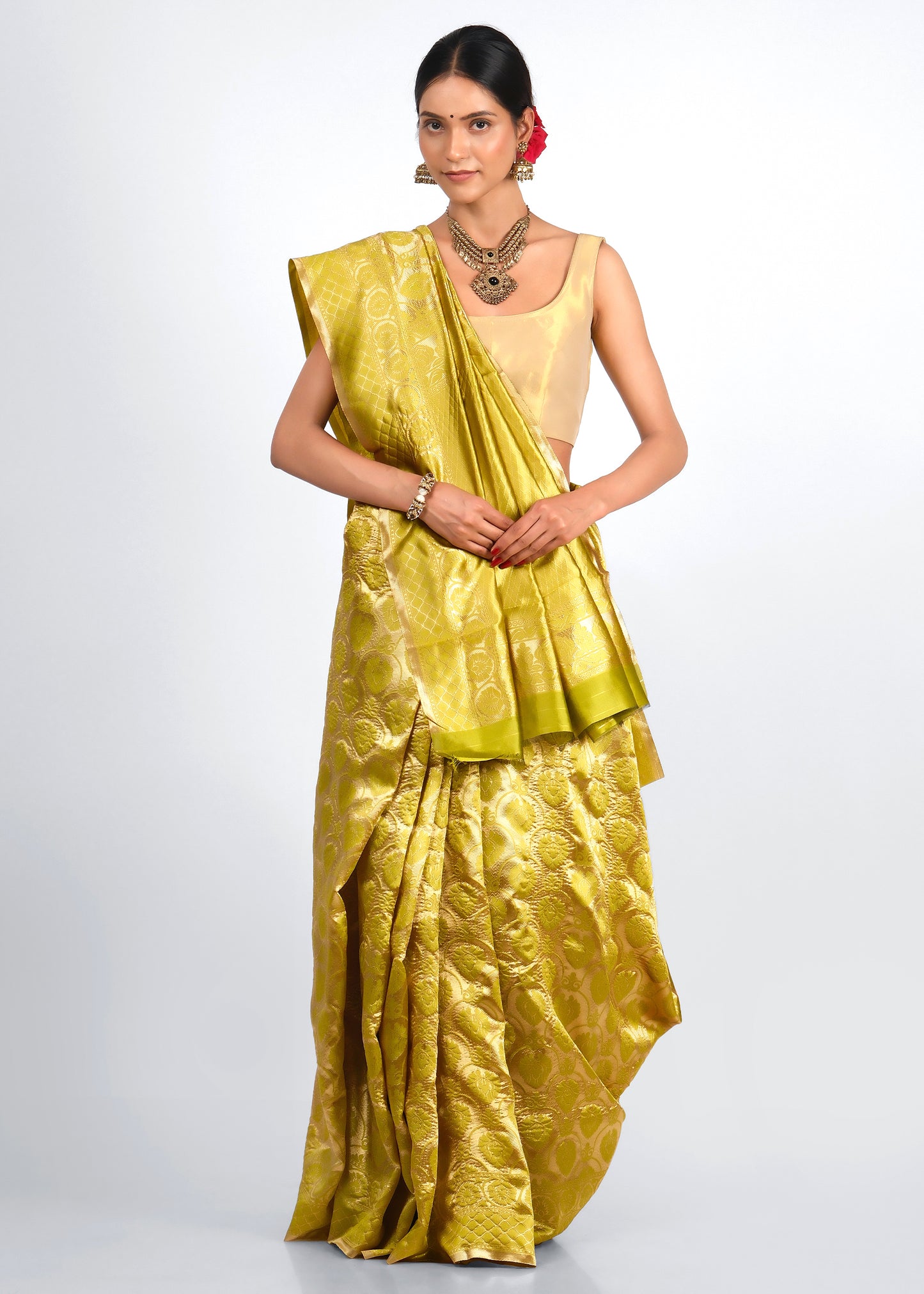 Elegant model draped in a yellow Banarasi silk saree with intricate golden floral patterns