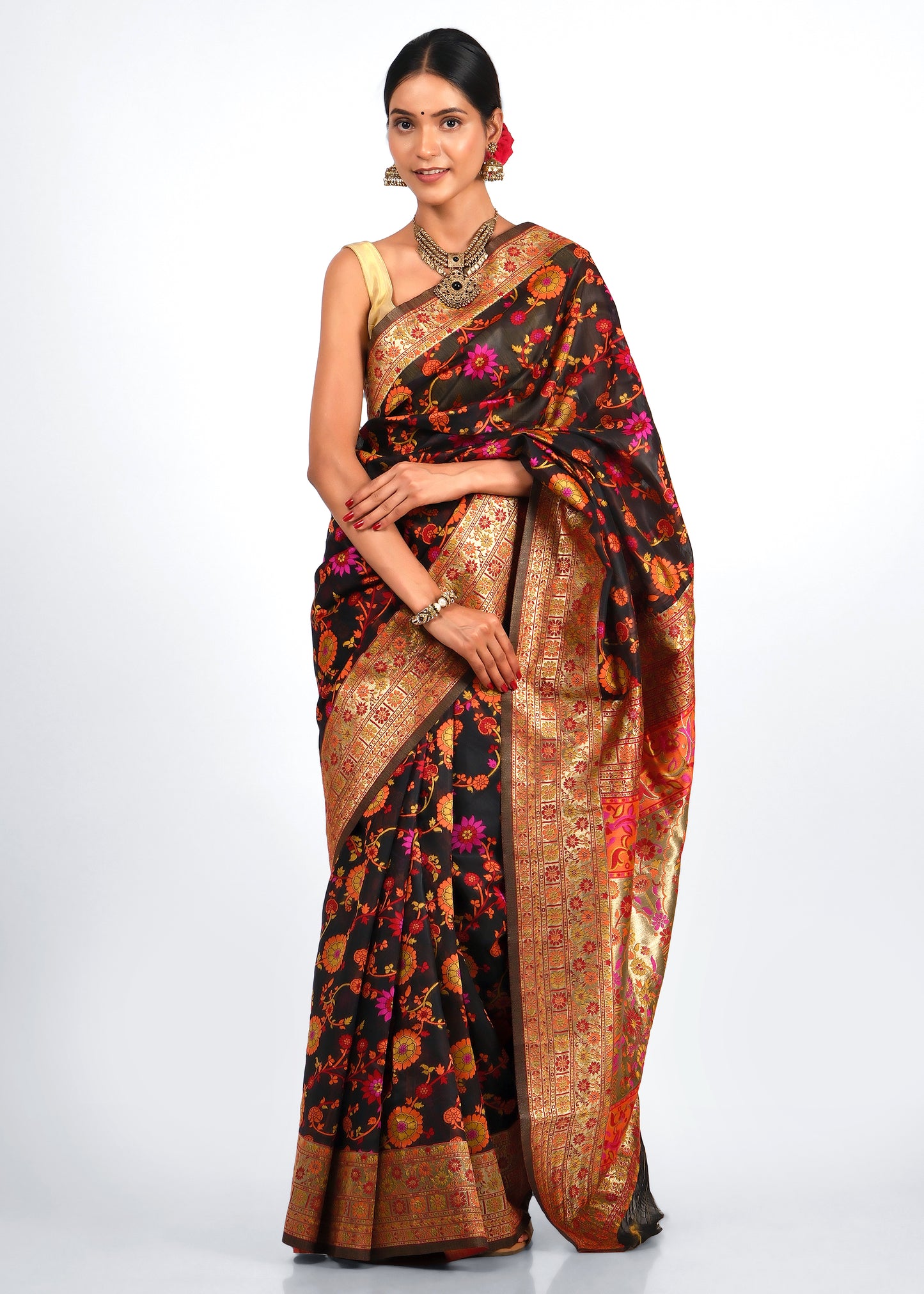 Model wearing a black floral Banarasi silk saree with intricate golden zari border, perfect for traditional occasions