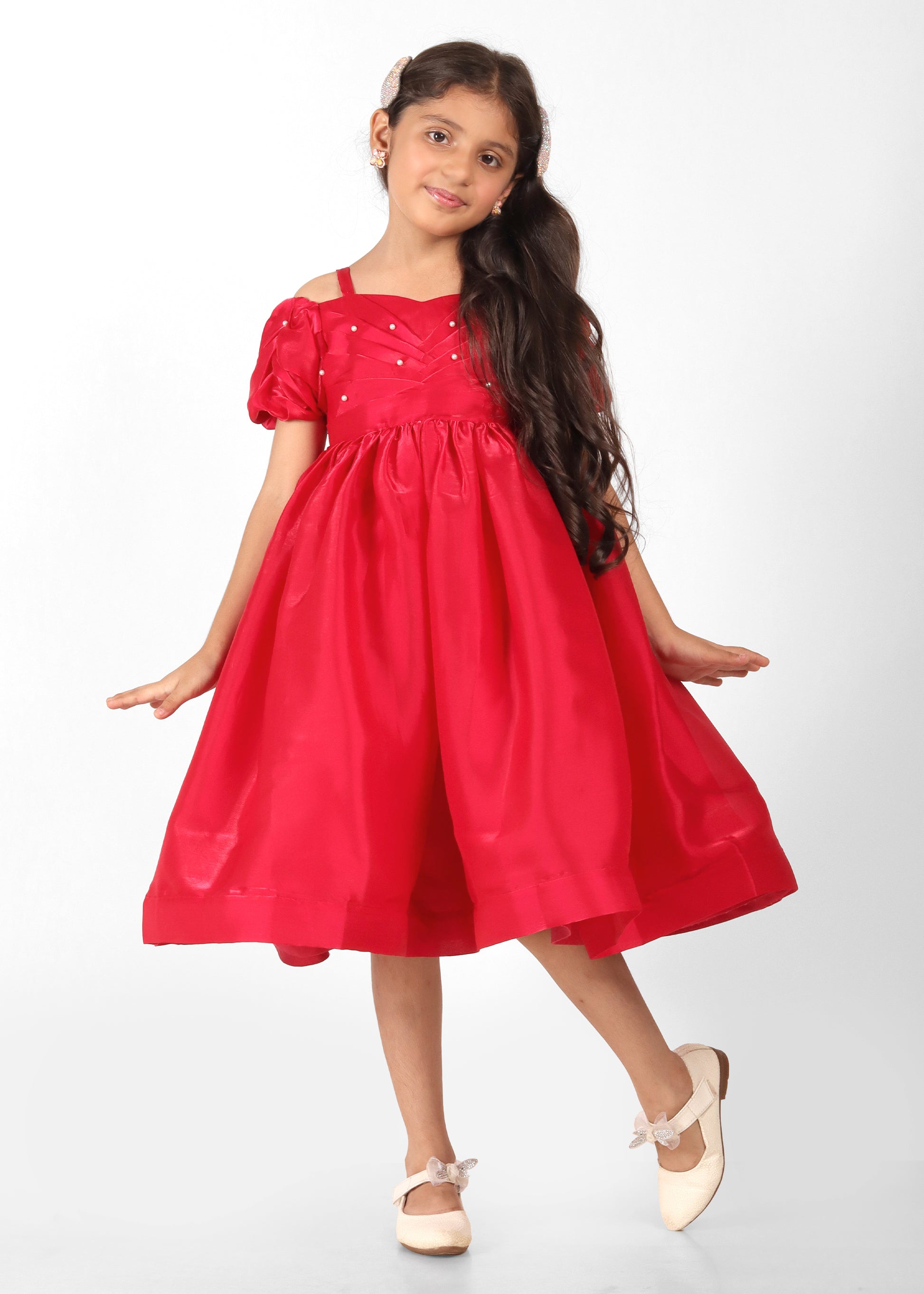 "Full-body shot of a young girl wearing a red dress with puff sleeves and a heart neckline, perfect for birthdays and special occasions."