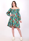 Woman wearing an off-shoulder A-line dress with vibrant jungle print, standing in a confident pose.