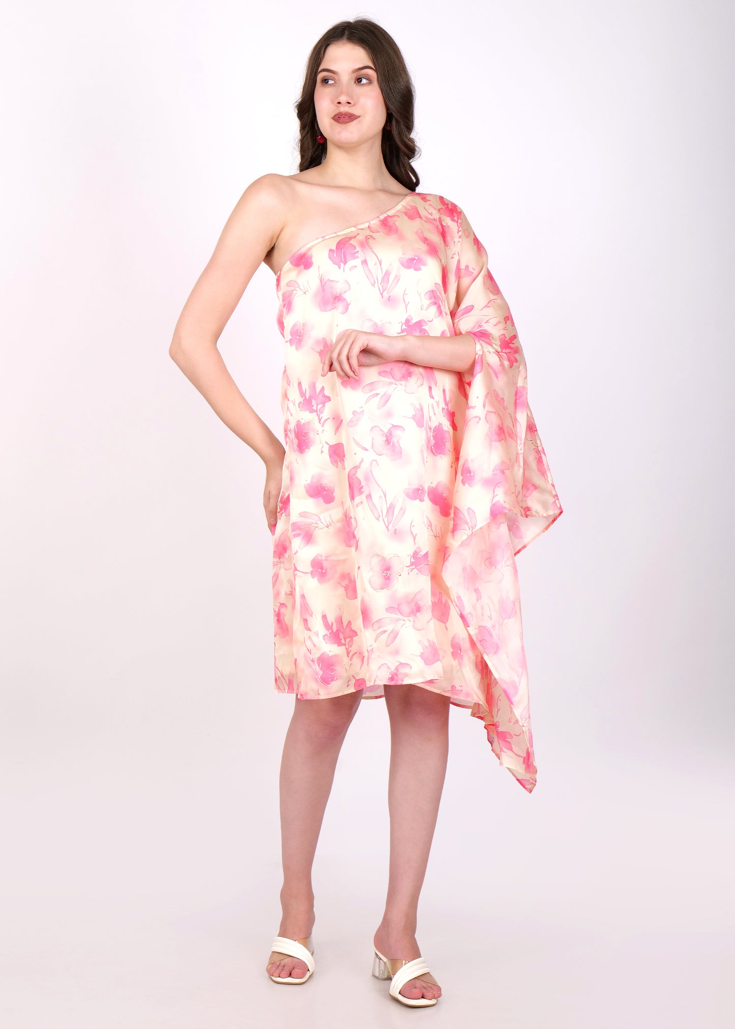 One-shoulder pastel floral dress with flowy pink and peach watercolor print, modeled from the side view