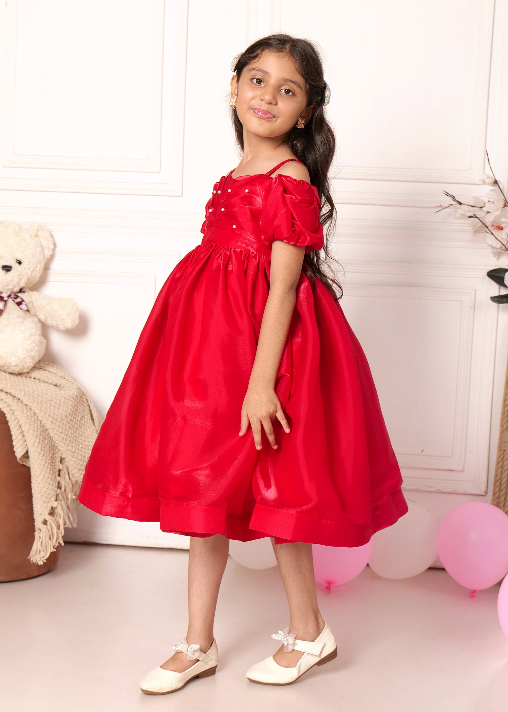 "Cute girl in a red satin puff sleeve dress, showing off her playful side with stylish pose, perfect for special occasions or festive gatherings."