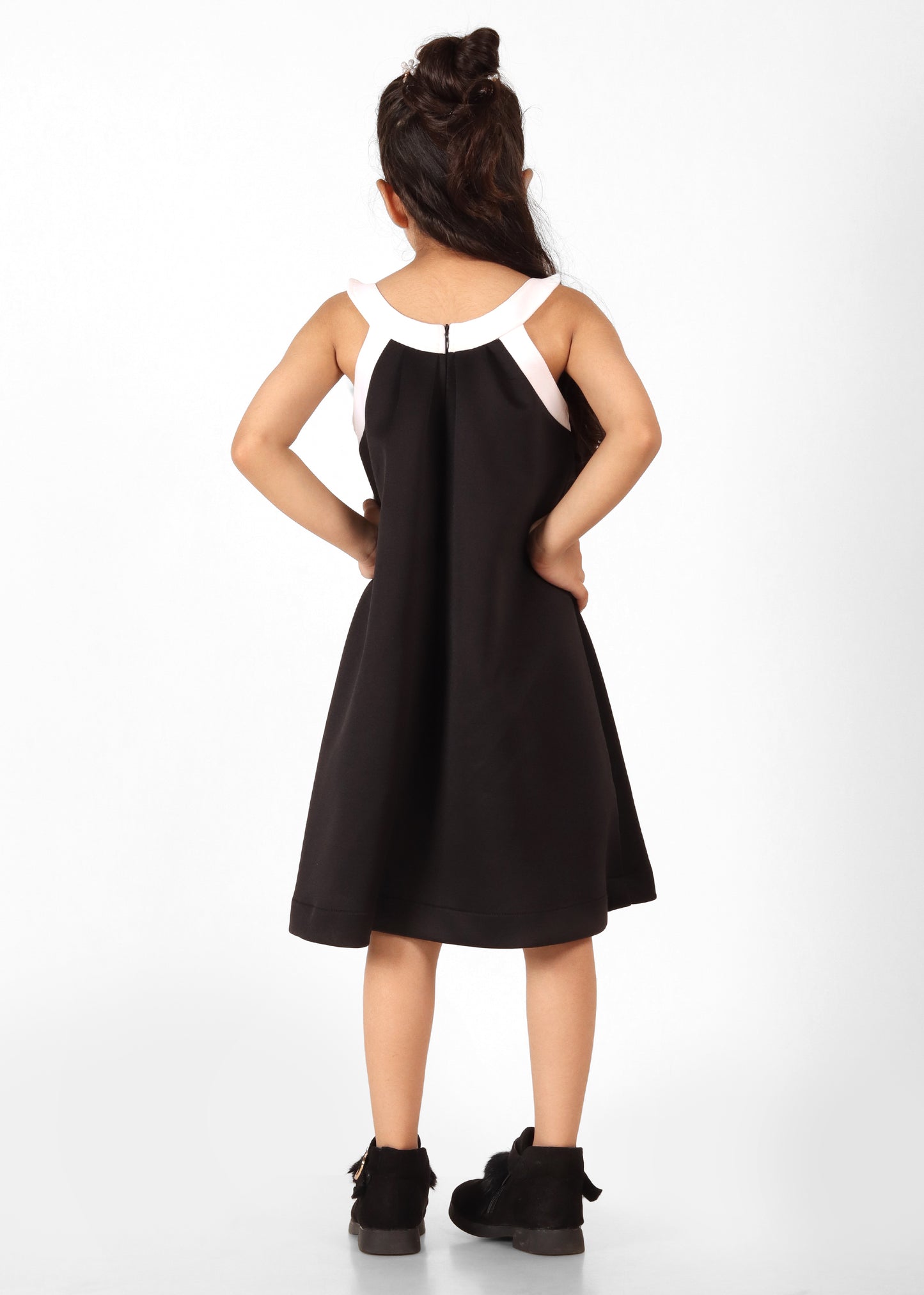 back of a black dress highlighting elegant contrast details."