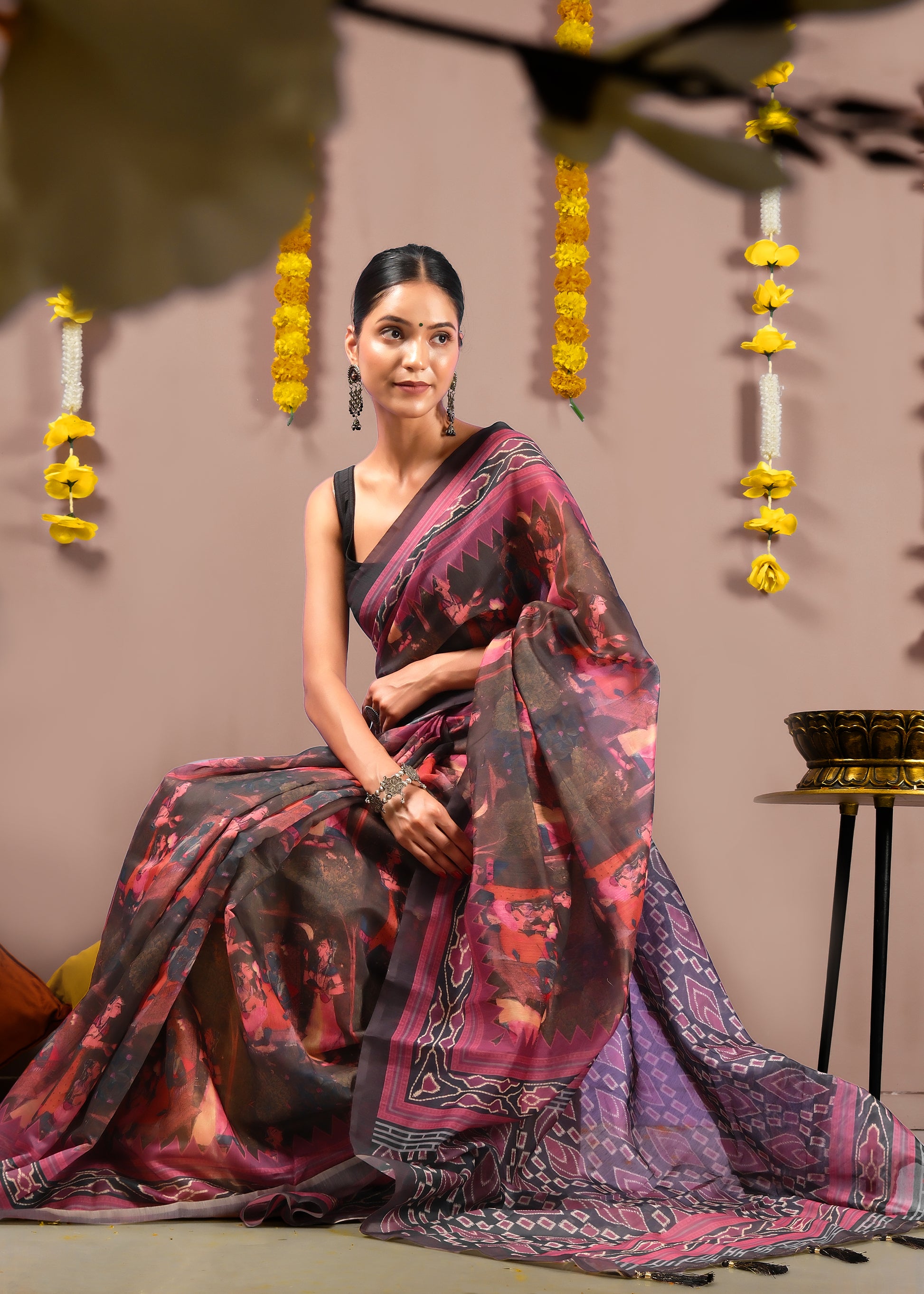 Side view of a woman wearing a Krishna Rasleela saree, highlighting the divine motif on the pallu.