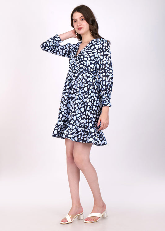 Side view of a model in a navy blue and white abstract printed dress, showcasing long sleeves and a flared silhouette for a comfortable yet stylish look