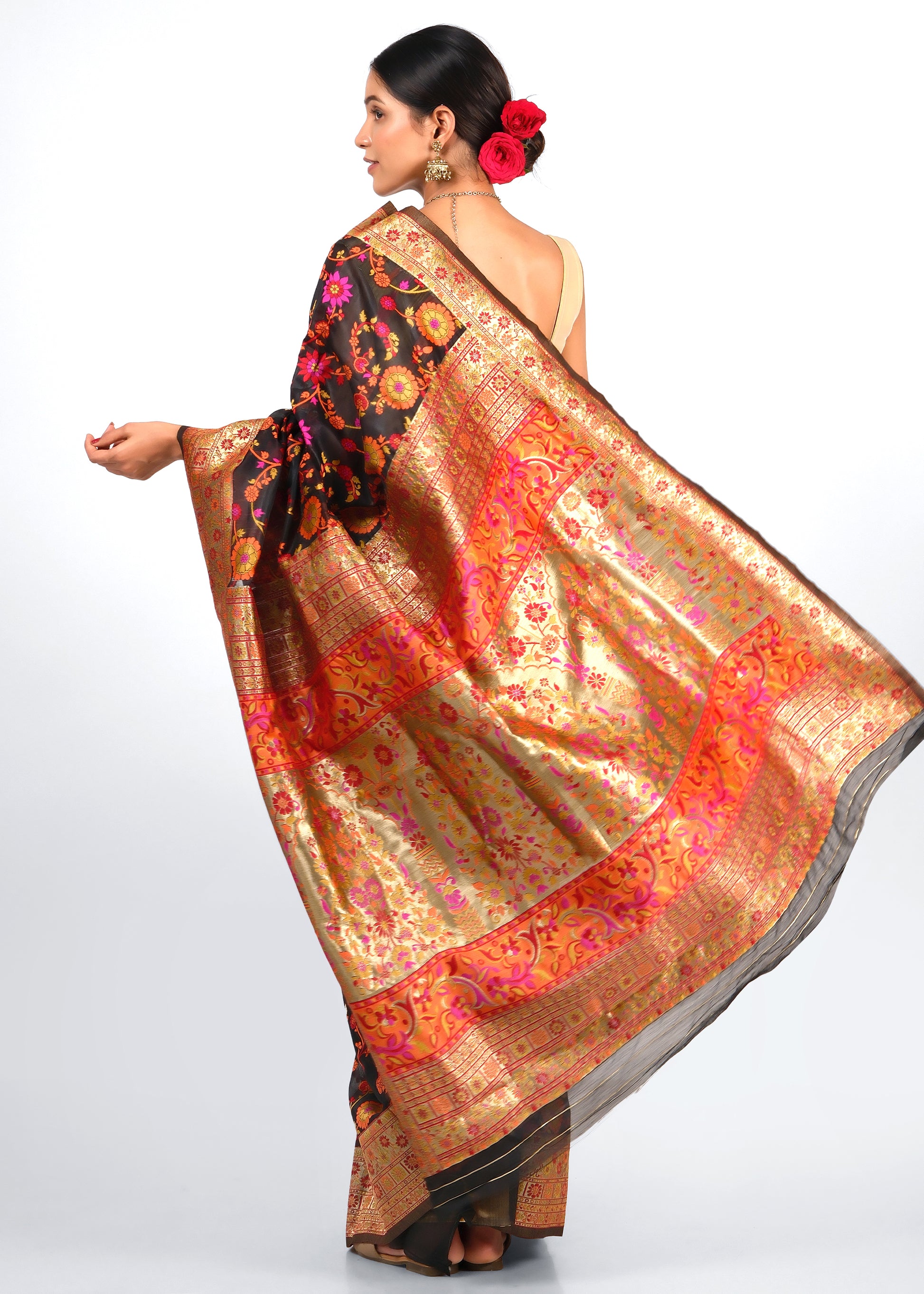 Back view of black Banarasi silk saree adorned with vibrant pink and orange floral motifs and luxurious gold border