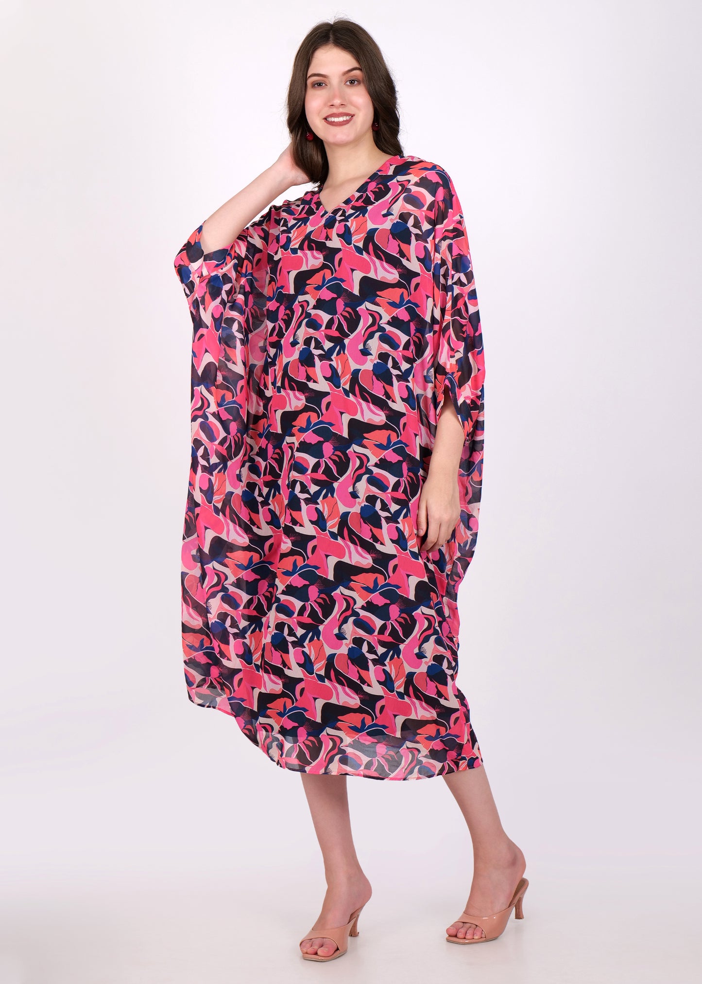 Side view of the model wearing a pink and purple abstract printed kaftan dress, showcasing the loose-fit design