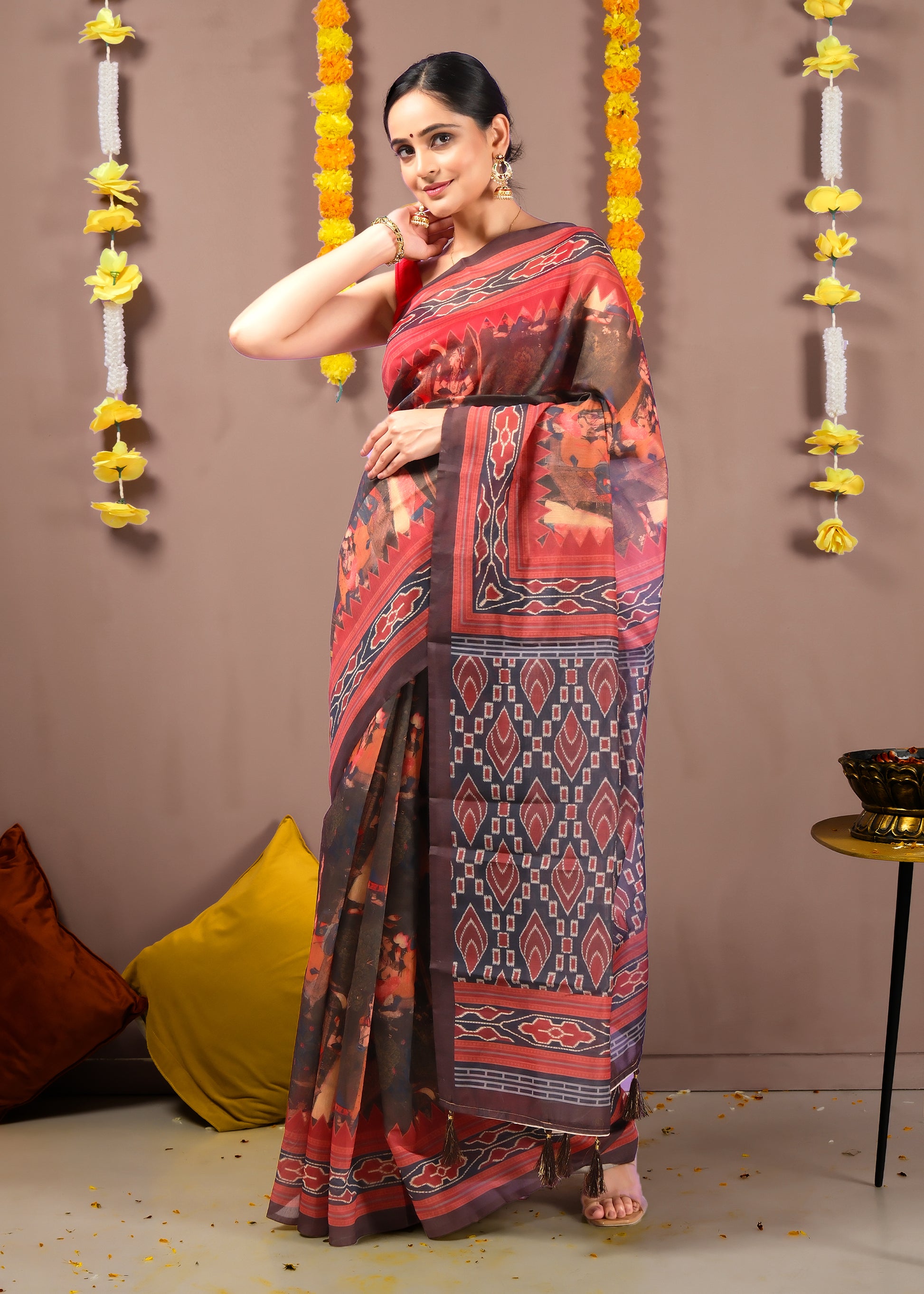 Full-length view of a woman wearing a handwoven Ikat saree with intricate patterns and a rustic appeal.