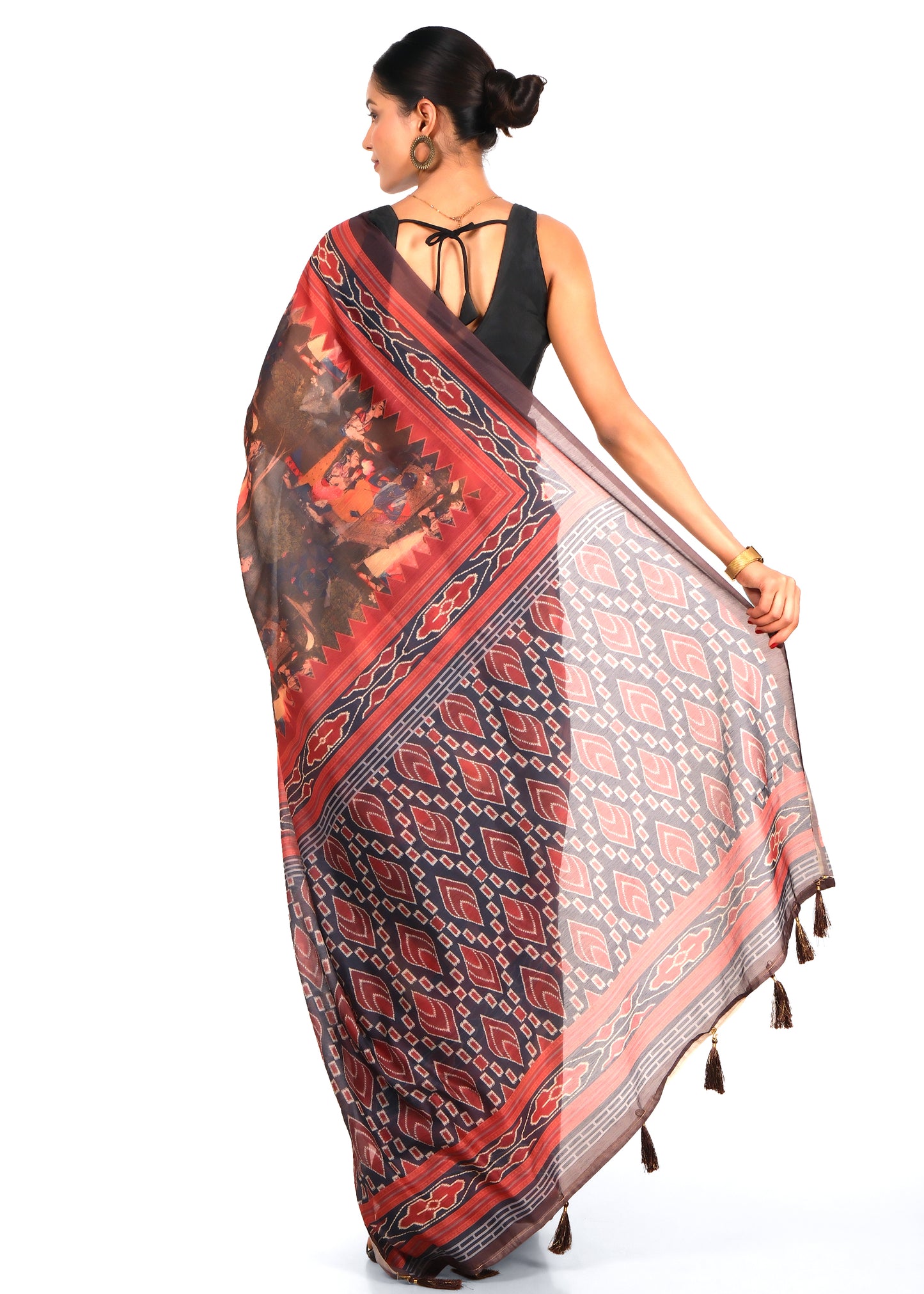 Model showcasing the back view of a red and black printed saree with detailed geometric and cultural designs, ideal for ethnic wear.