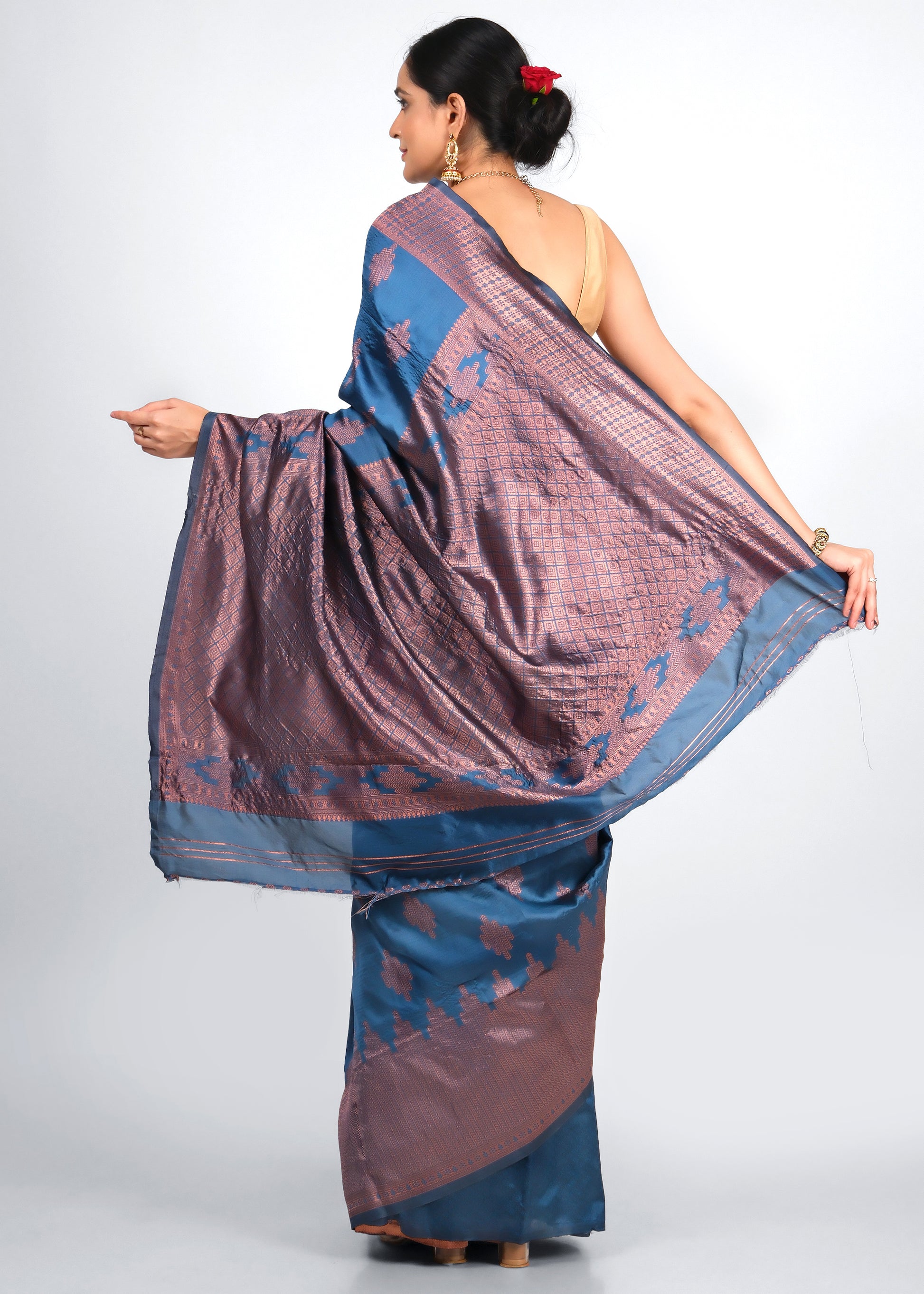 Back view of royal blue and copper woven silk saree showcasing rich pallu design and traditional blouse pairing