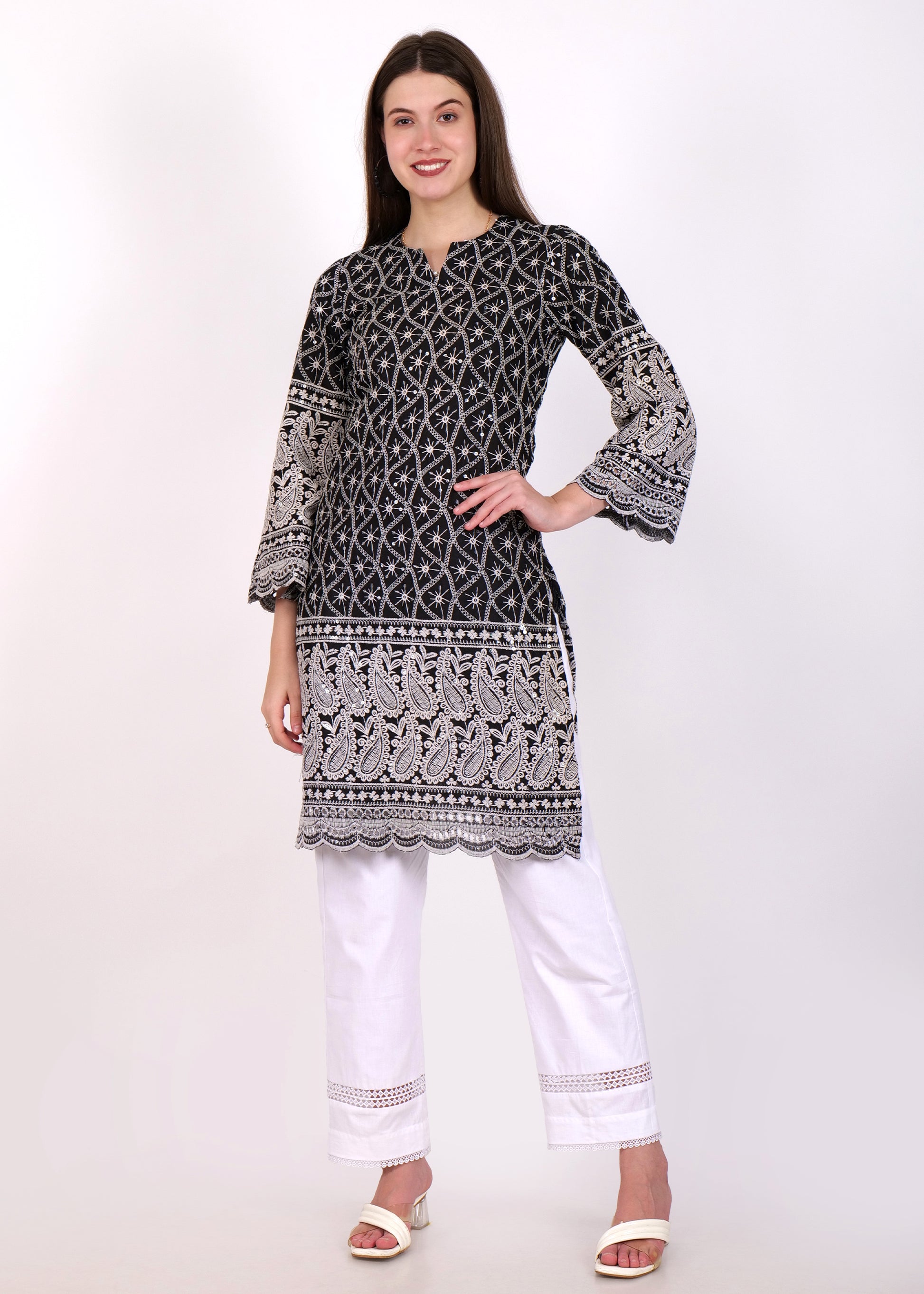 Front view of a black embroidered ethnic kurta with white paisley pattern detailing and comfortable white pants