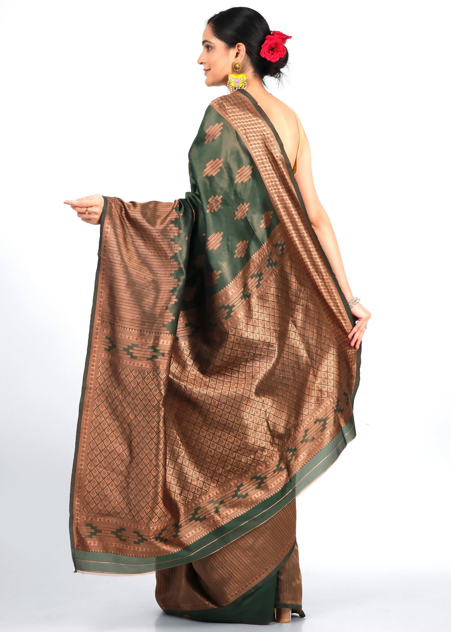 Back view of a green and brown silk saree with detailed gold patterns, styled traditionally