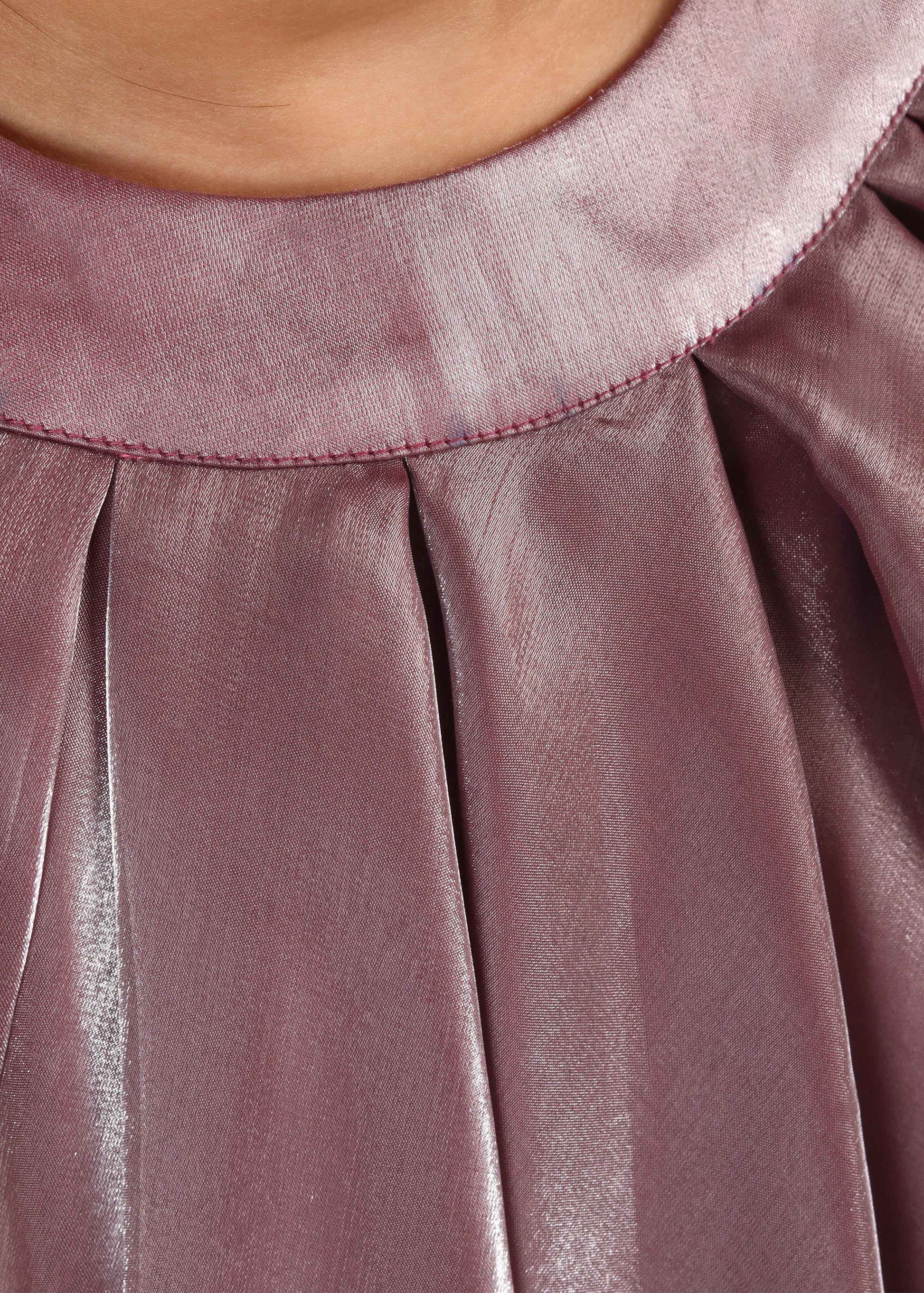 Close-up of a mauve layered sleeveless dress with delicate pleats, showcasing the shimmering texture for kids' fashion