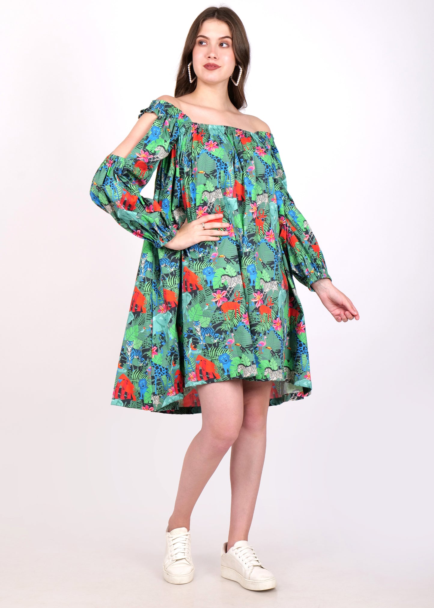 Full view of a woman in a jungle-themed off-shoulder dress, looking to the side and striking a poised pose