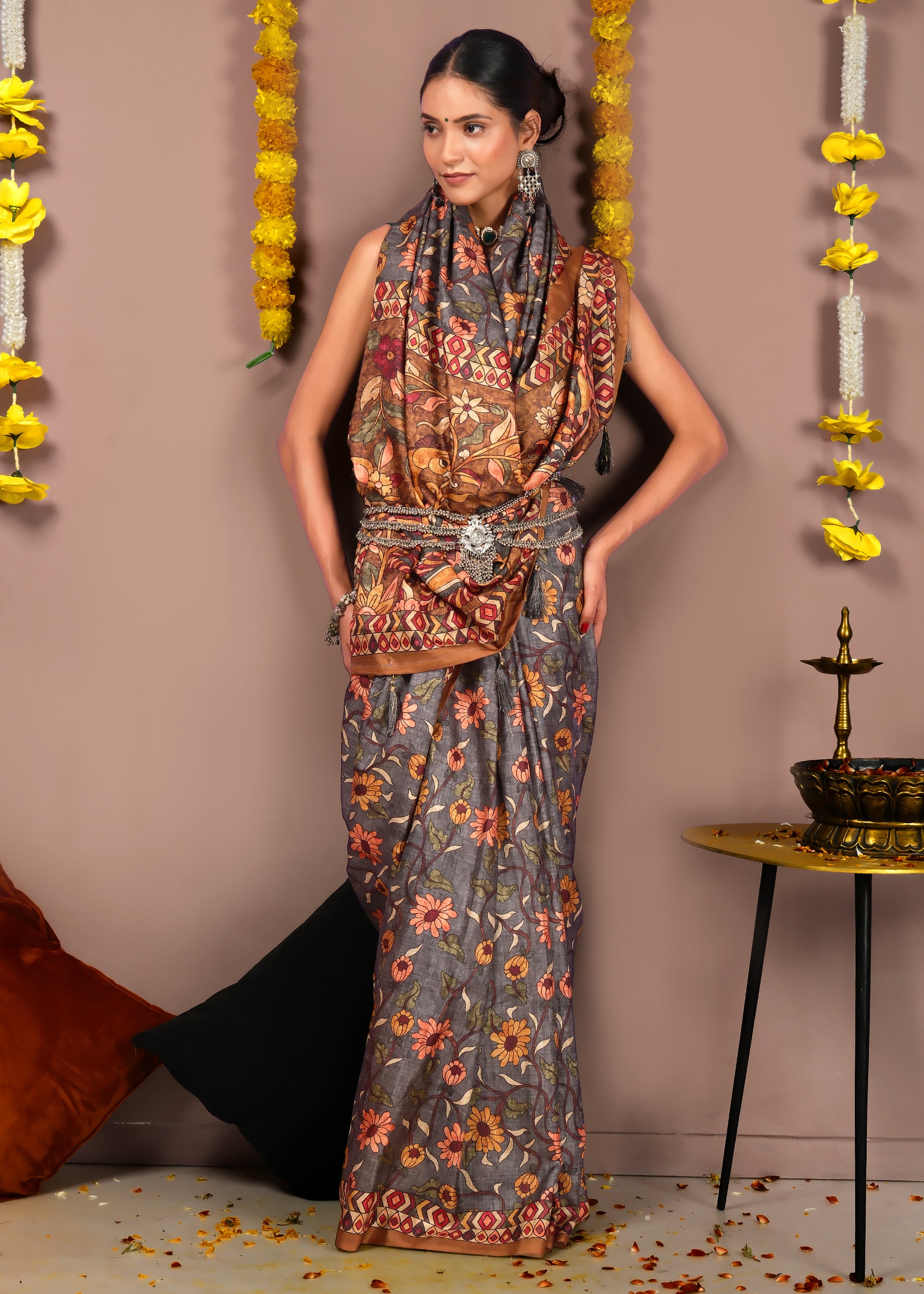 Stylish woman in a traditional floral printed saree with ethnic accessories